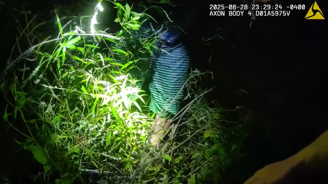 Still image from police bodycam footage of the man being found in the marsh.
